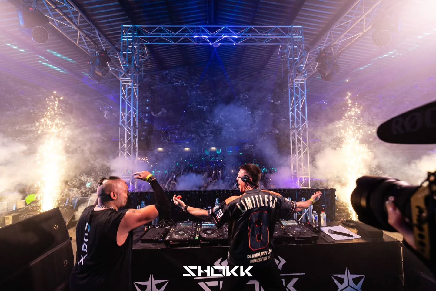DJs celebrating on stage with close proximity fireworks and CO2 effects